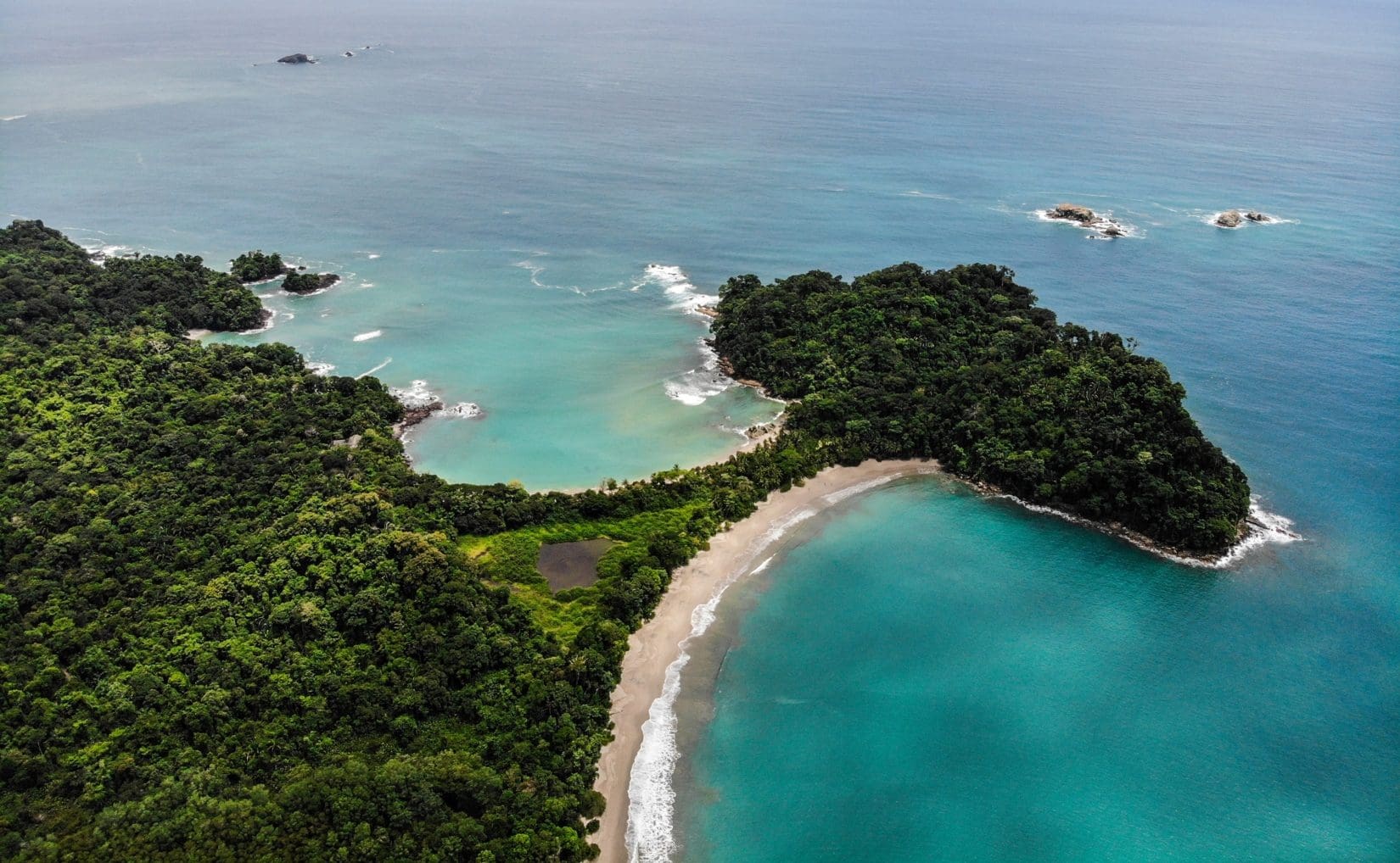 View of Playa Espadilla and Playa Manuel Antonio separated by the Punta Catedral