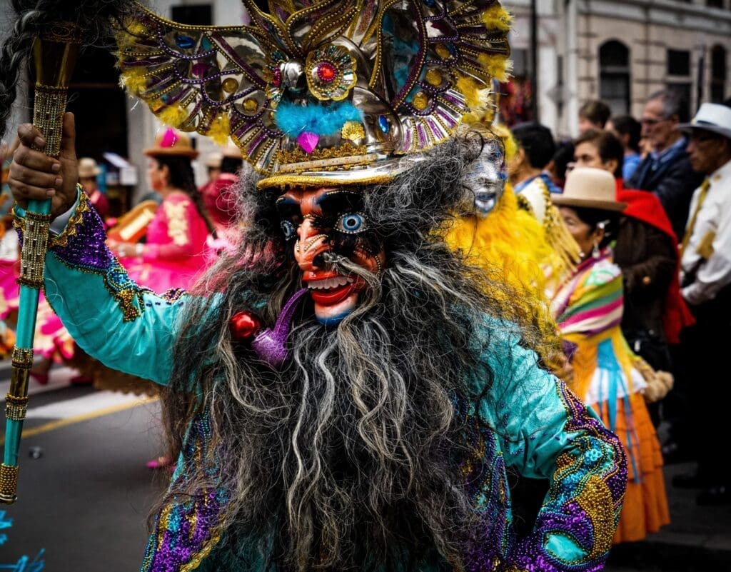 South American costumed dancer in mask participating in a parade during the Virgen del Carmen Festival, Peru